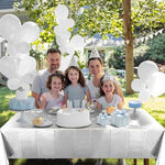Silver metallic tablecloth draped over a long rectangular party table