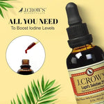 Glass dropper dispensing liquid iodine solution for water purification or supplementation.