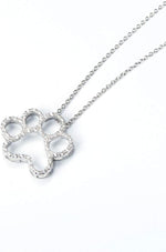ONEFINITY sterling silver dog paw pendant with shimmering cubic zirconia stones close up view