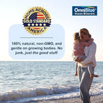 OmniBlue ocean minerals supplement being dropped into a fresh fruit smoothie.