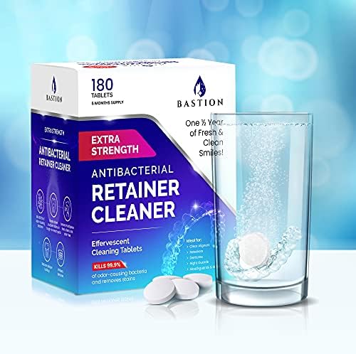 Clear dental aligners and mouth guards next to the mint flavored cleaning tablets packaging