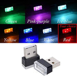 Mini LED universal ambient lights plugged into a car dashboard USB port emitting a red glow.