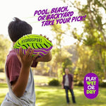 Bright lime green HydroSport pool toy football resting on a sandy beach side profile.