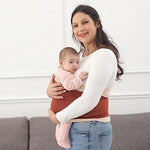 Side view of an infant resting in an ergonomic M-position inside a natural color baby sling