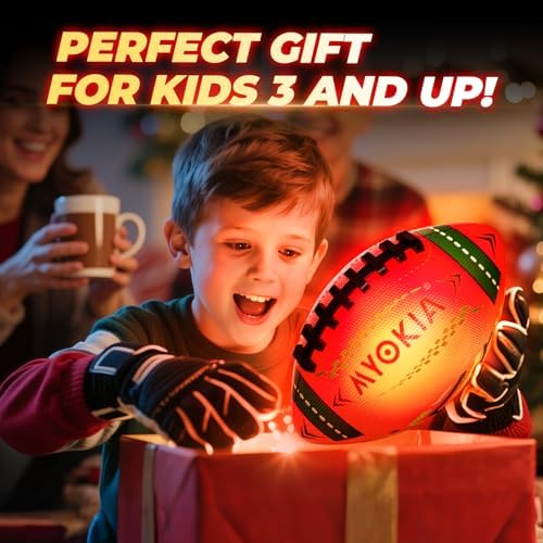 Youth size six colorful glowing football being thrown during outdoor night games
