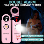 Pink Guiartec 135dB safety alarm keychain on a bag