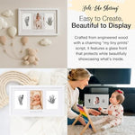 White engineered wood baby keepsake frame with glass cover displaying infant prints