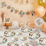 Osonm cowboy party supplies set displayed on a rustic wooden party table.