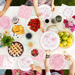 Pink bow birthday banner and tablecloth setup for party decor