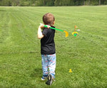 Toddler holding an Orzizro plastic golf club for size reference