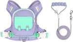 Small dog wearing pink reflective harness backpack in outdoor setting