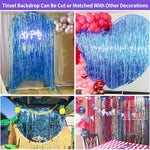 Two packs of JINSUI dark blue tinsel backdrops layered together to create a dense photo booth wall.