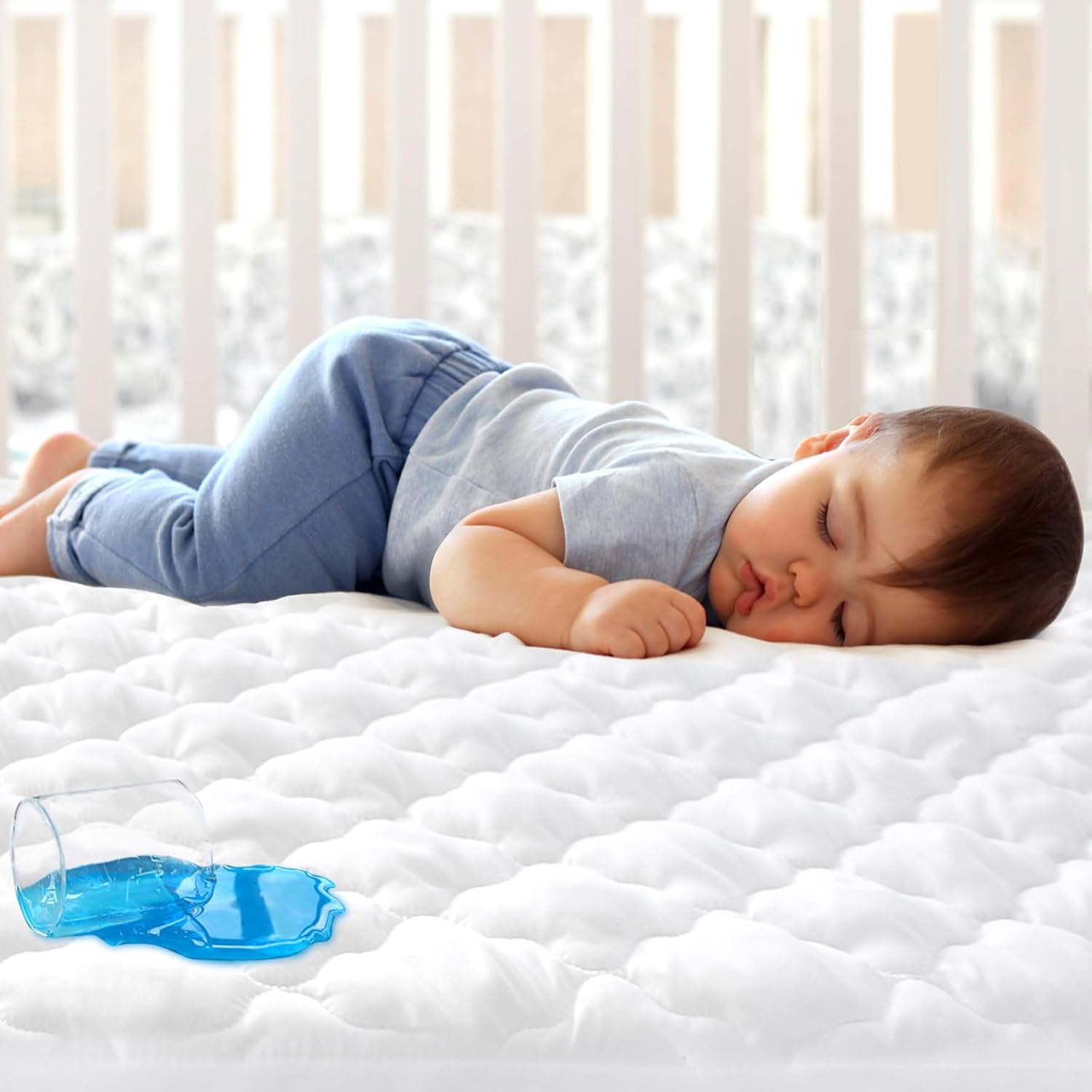 Biloban crib mattress protector sheet front view showing white quilted texture.
