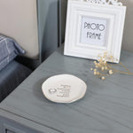 Top angle shot of the ring dish with small earrings and necklace