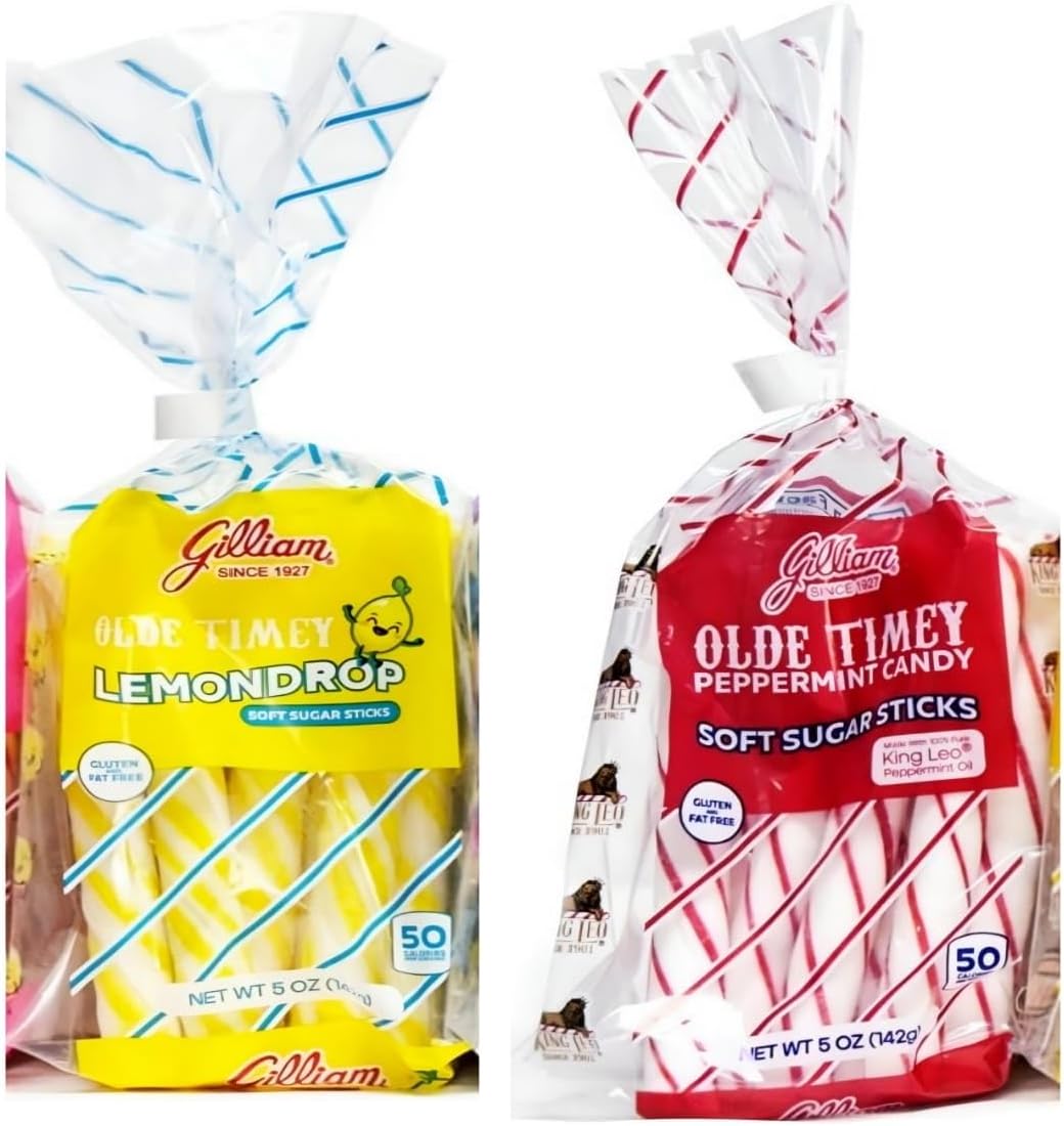 Close up of striped red and white peppermint candy sticks on a white background.
