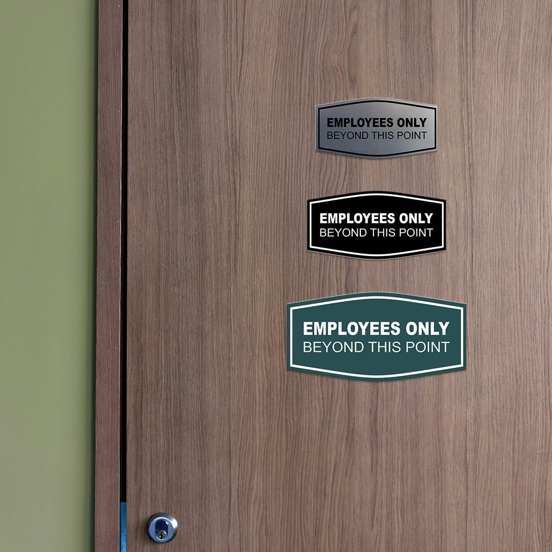Brushed gold restricted area sign mounted on office door