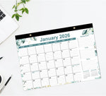 Calendar displayed flat on a desk surface as a blotter pad