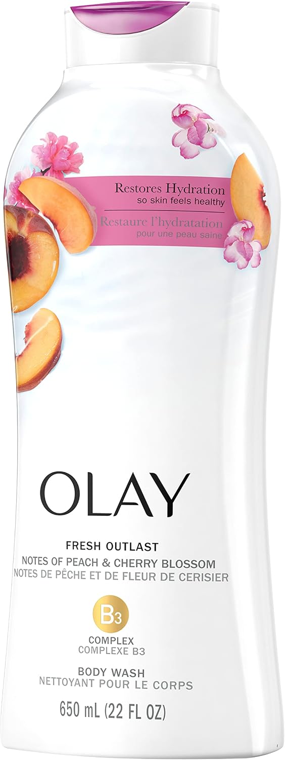 Olay body wash bottle displayed with peach slice and floral graphics
