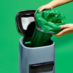 Eco-friendly plastic free cat litter pail liners being fitted onto an empty cartridge rim.