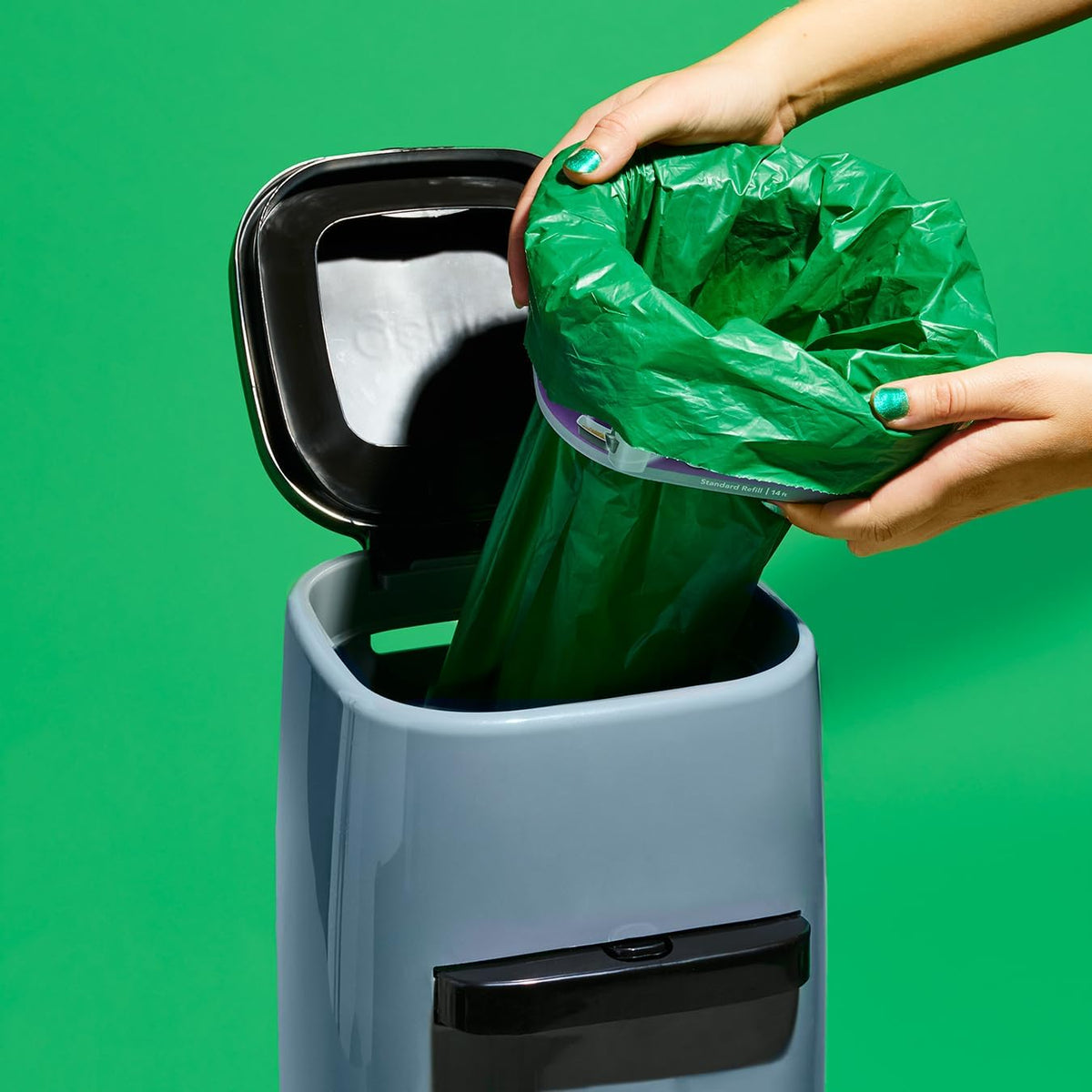 Eco-friendly plastic free cat litter pail liners being fitted onto an empty cartridge rim.
