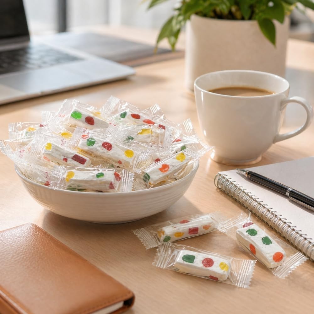 DM Sweets Jube Nougats candy pack being poured into a transparent glass office candy jar.