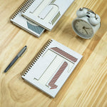 Collective Home Monogram Notebook opened flat on a desk