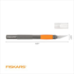 Fiskars orange ergonomic craft knife held in hand for detailed scrapbooking