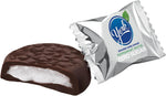 Close up view of a single YORK zero sugar peppermint patty cut in half displaying the white mint center.