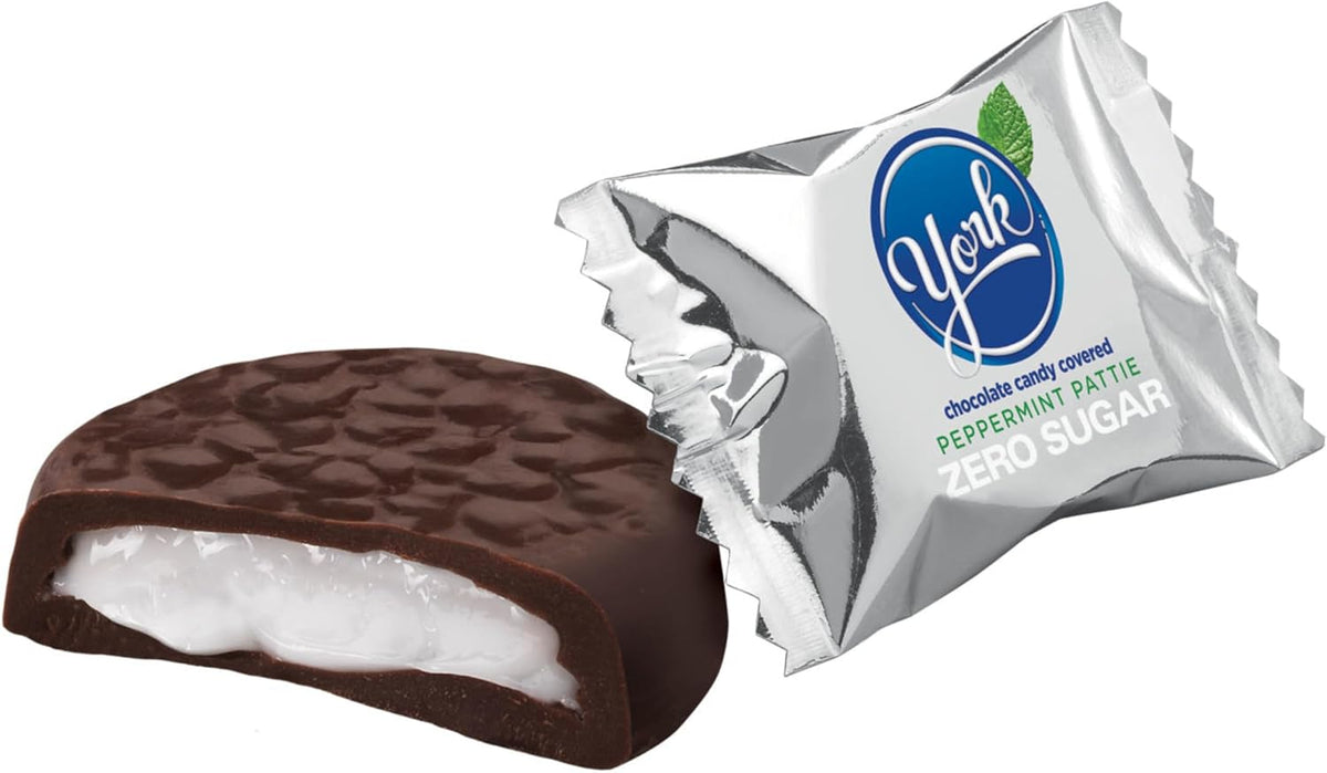 Close up view of a single YORK zero sugar peppermint patty cut in half displaying the white mint center.