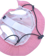 Large dog wearing pink sun protection hat outdoors