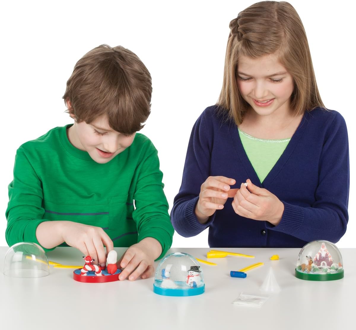 Creativity for Kids holiday snow globes kit shaking activity showing snow effect.