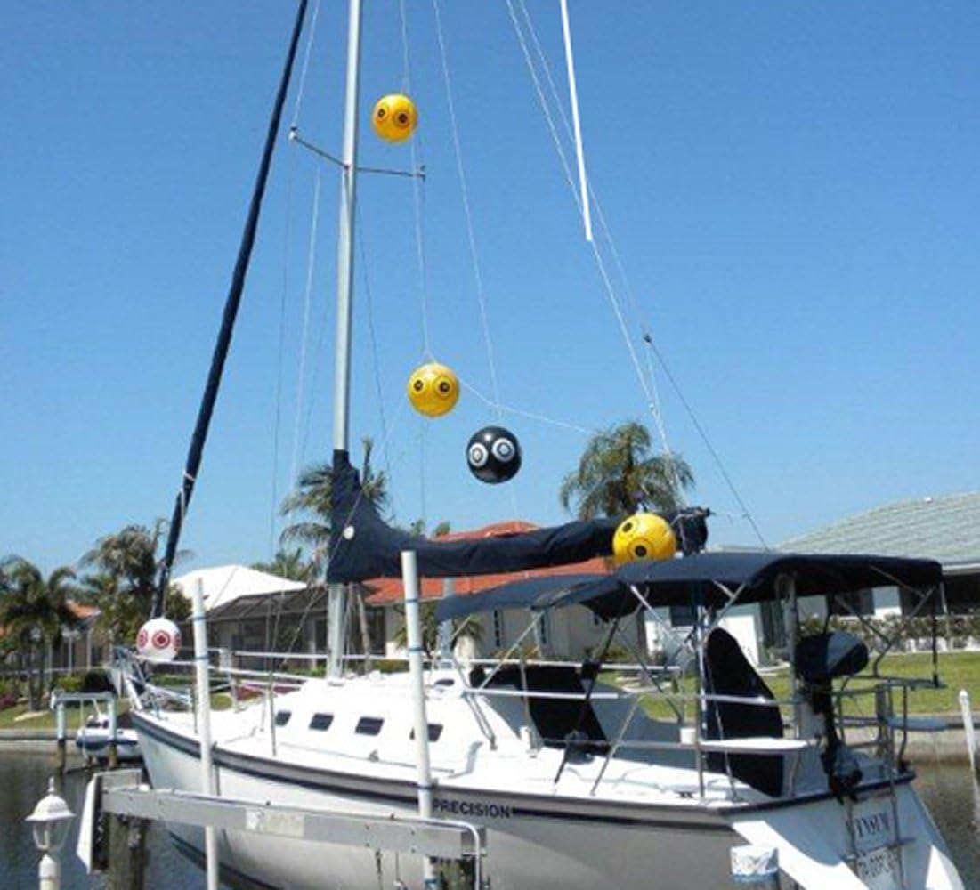 Bird-X Scare-Eye Balloon hanging in outdoor garden setup