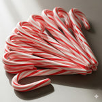 Traditional peppermint candy canes packed in seasonal boxes for holiday gifting.