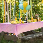 Pale pink holographic tablecloth used as a shimmering wall backdrop