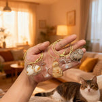 Mini cat shaped fur storage keyring lying flat on a neutral background surface