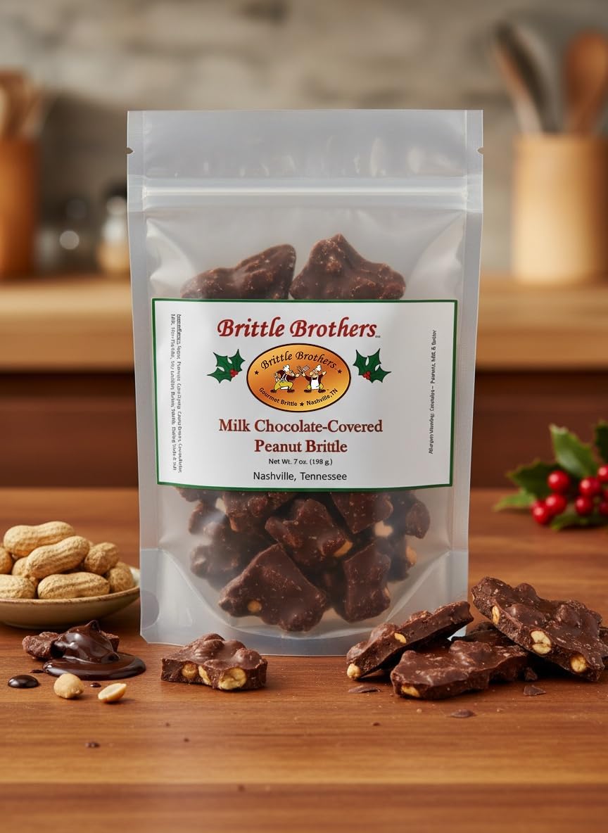 Handcrafted chocolate covered peanut brittle gourmet candy pieces on a wooden board