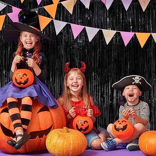Halloween theme party setup featuring black tinsel background streamers
