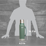 Stanley imported green thermal bottle being held by its sturdy handle