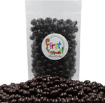 Two pound bag of dark chocolate covered espresso beans on a rustic table