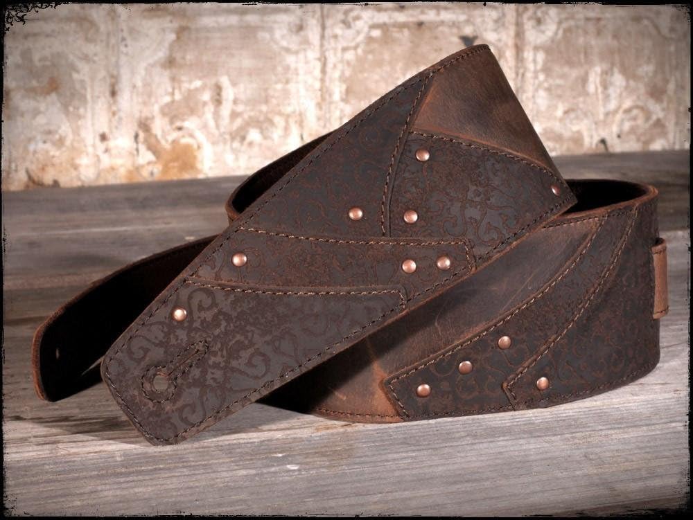 Anthology Gear Overland leather guitar strap resting on acoustic guitar body