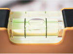 Harfington mini bubble level placed next to a measuring scale