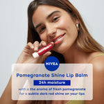 Nivea lip care product next to fresh pomegranate fruit