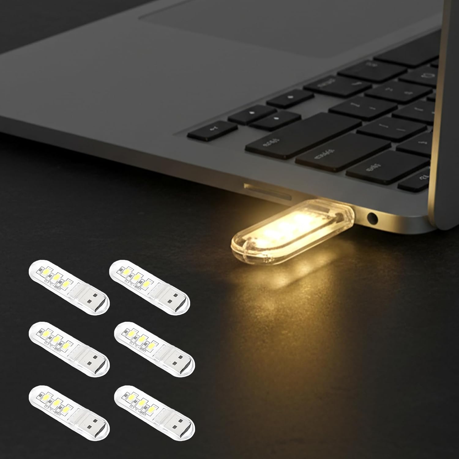 Justcellz 6 Piece USB Night Light front view showing compact mini LED bulbs plugged into a laptop port.