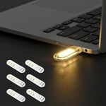Justcellz 6 Piece USB Night Light front view showing compact mini LED bulbs plugged into a laptop port.