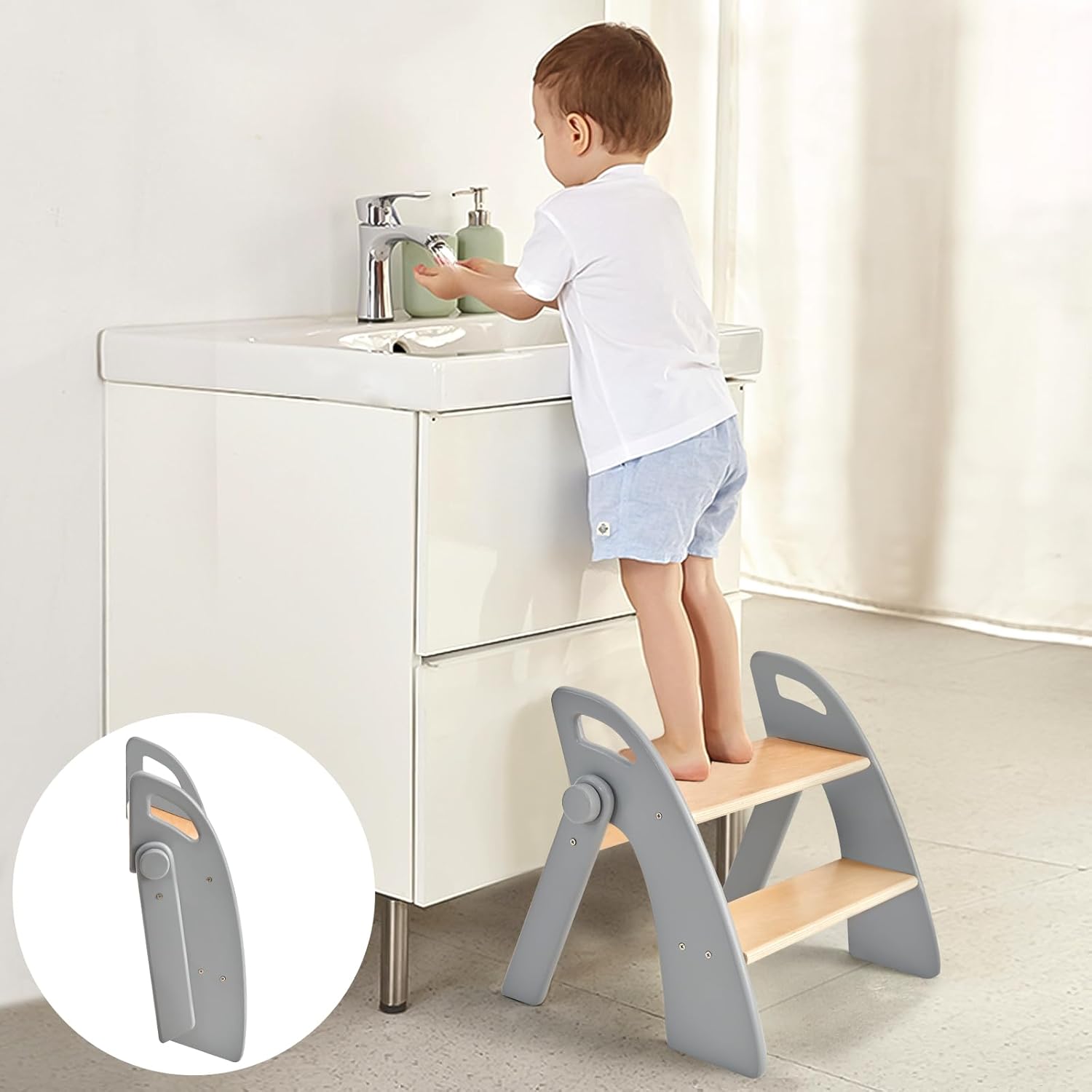 Joothlin wooden two step stool for kids front view showing grey foldable design near a bathroom sink.