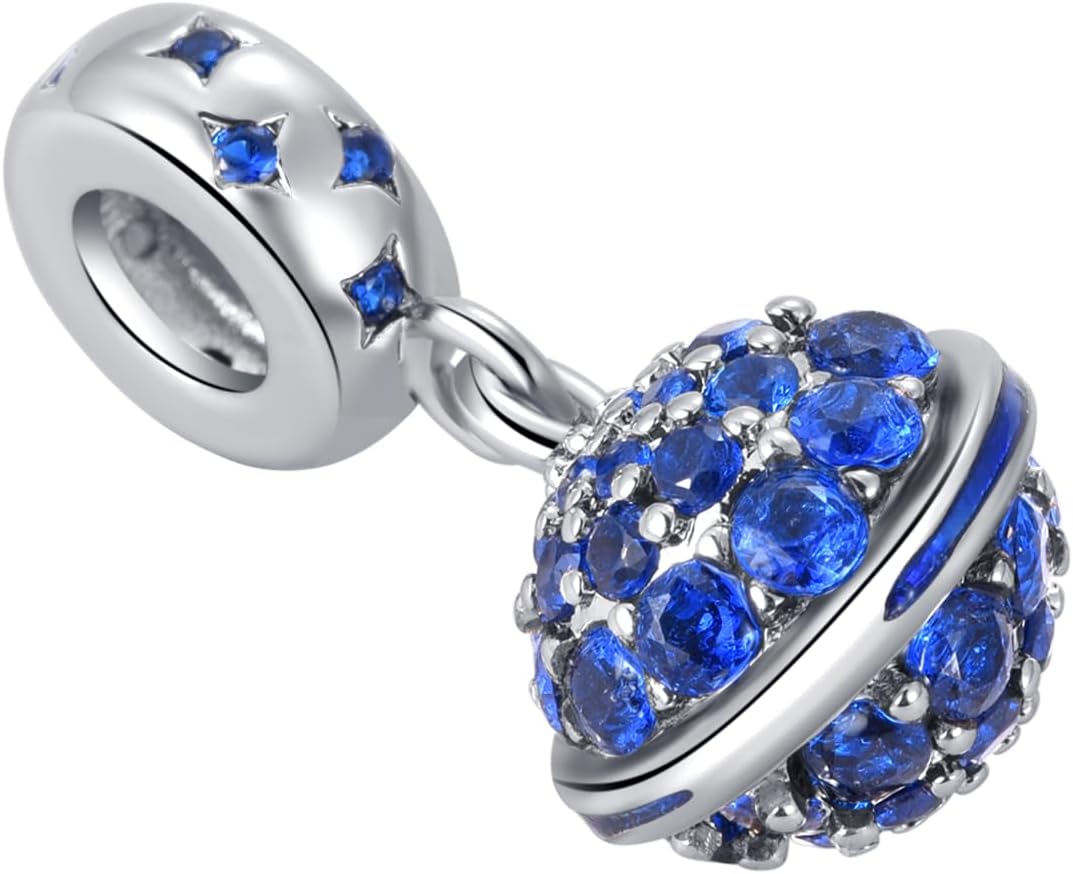 Detailed close up of blue cubic zirconia stones on the planet dangle charm