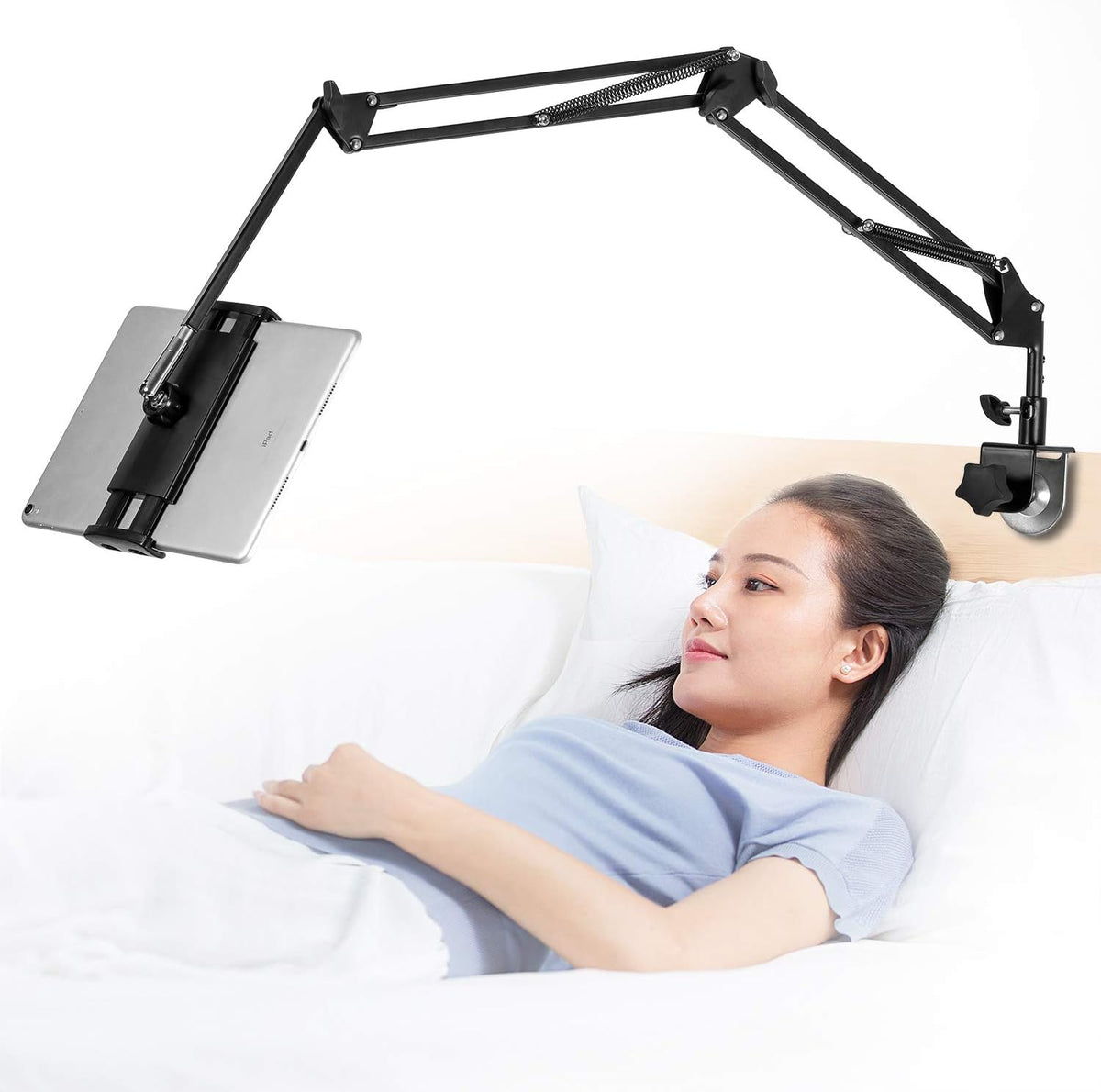 Samhousing adjustable tablet stand front view mounted to a wooden desk holding an entertainment device.