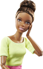 Barbie doll posed sitting cross-legged showcasing torso and hip joints.