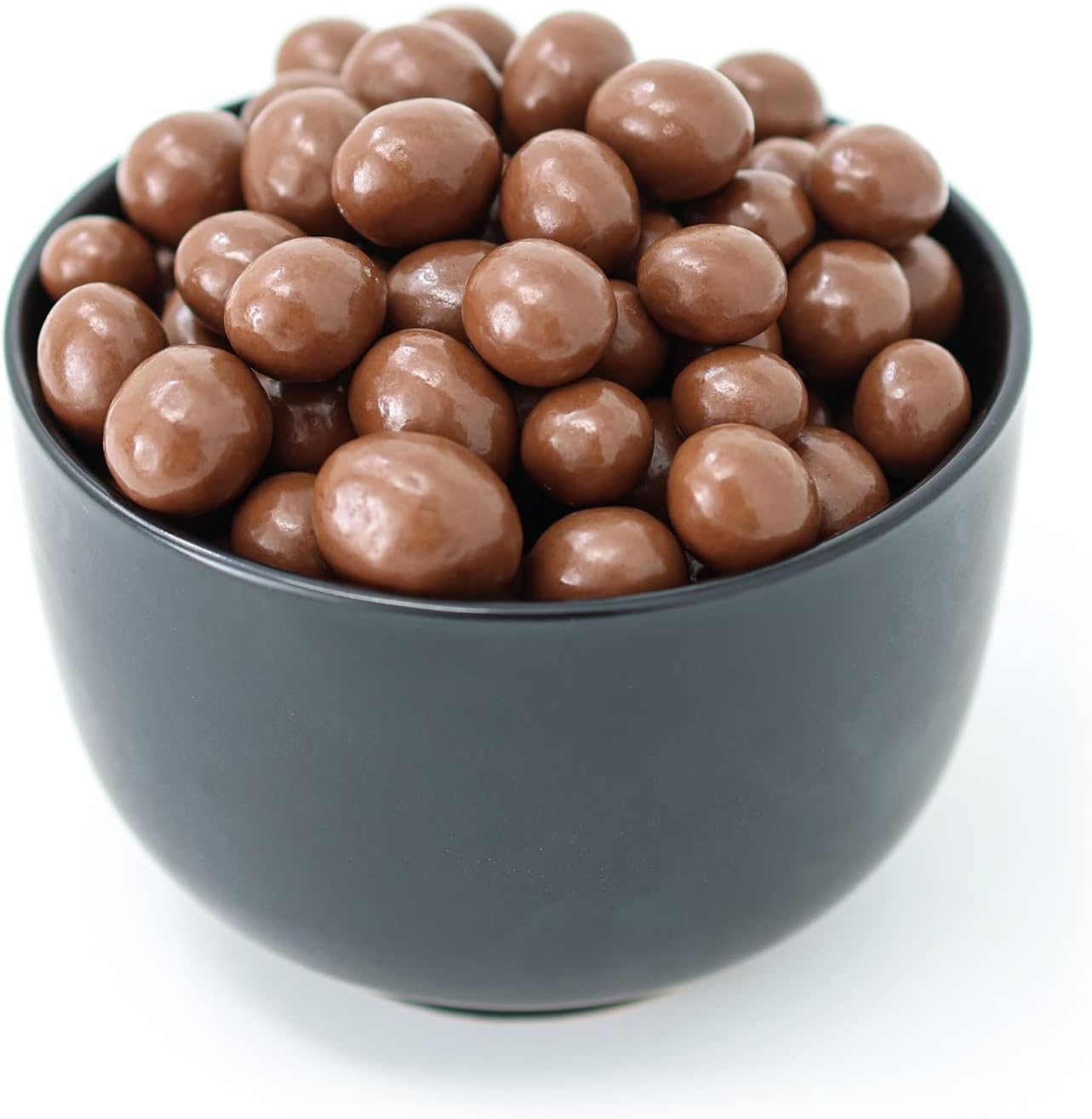 Close up of chocolate covered espresso beans with caramel and sea salt texture