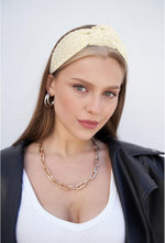 YISSION wide pearl headband angled side profile highlighting top-knot design.